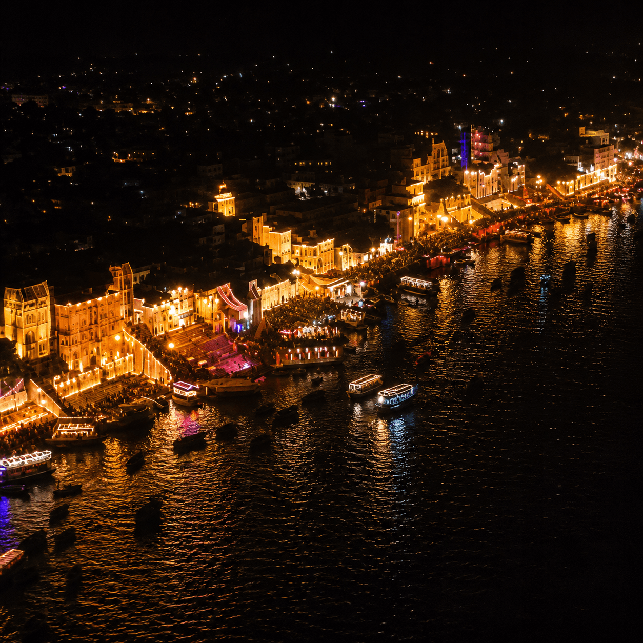 All 84 ghats glowing, wide shot